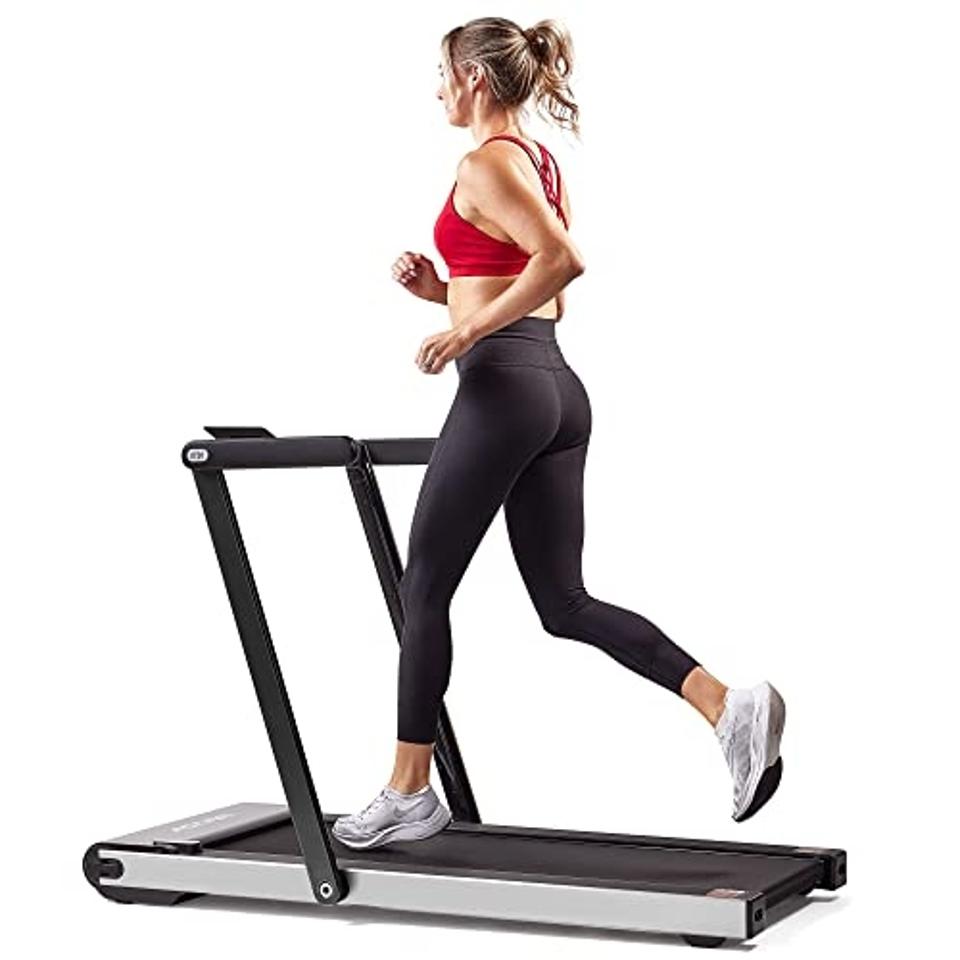 Woman running on a Sunny Health & Fitness Asuna Treadmill.